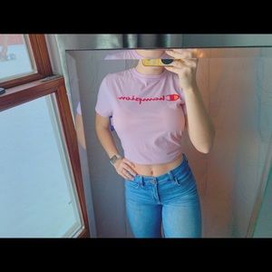 This is a medium baby pink champion t-shirt.